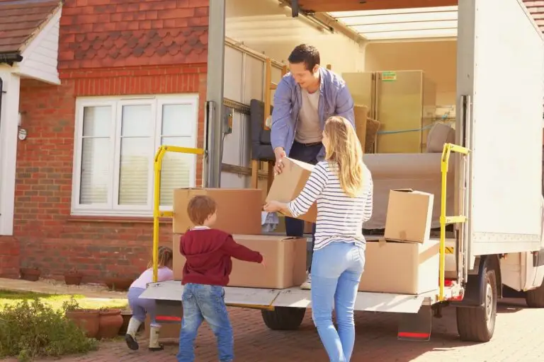 Family loading boxes into a moving truck